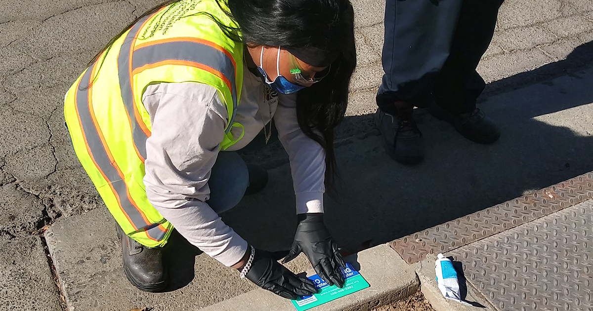 LCC Corpsmembers install safety placards to storm drains
